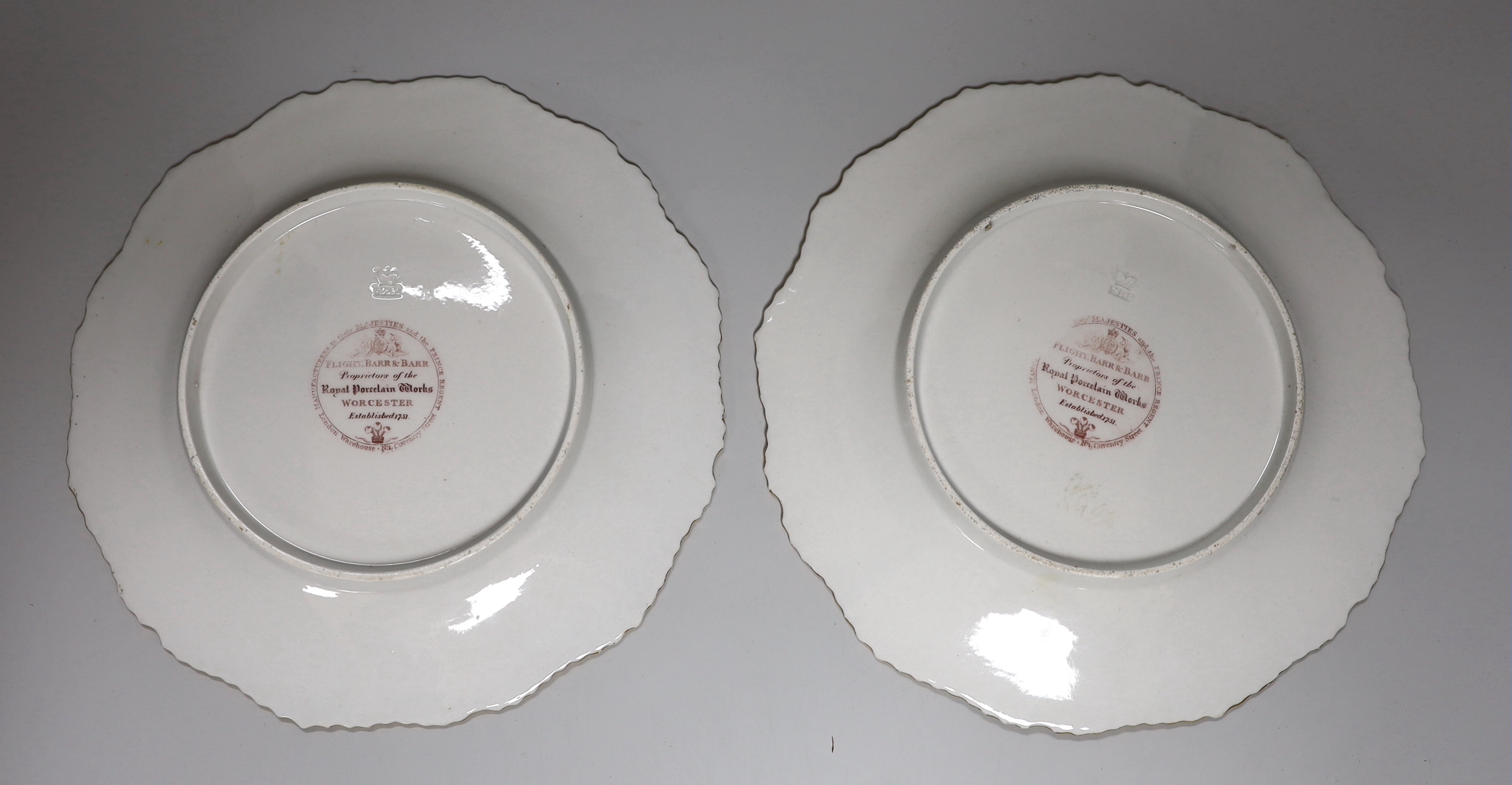 A pair of Flight, Barr and Barr Worcester plates, painted with central bouquets, c.1820, printed circular marks and impressed FBB crown, each 22cm in diameter